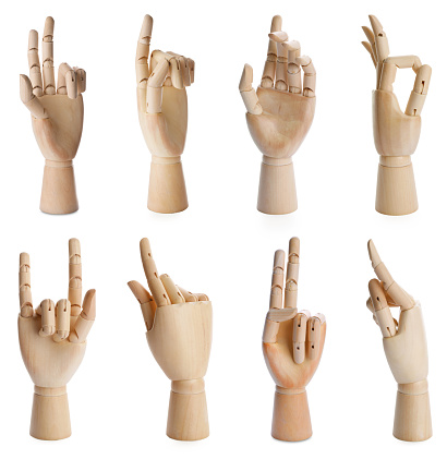 Set with wooden hands of mannequins showing different gestures on white background