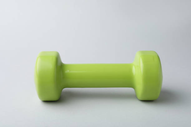 istock One new green vinyl dumbbell on light background 1479535317