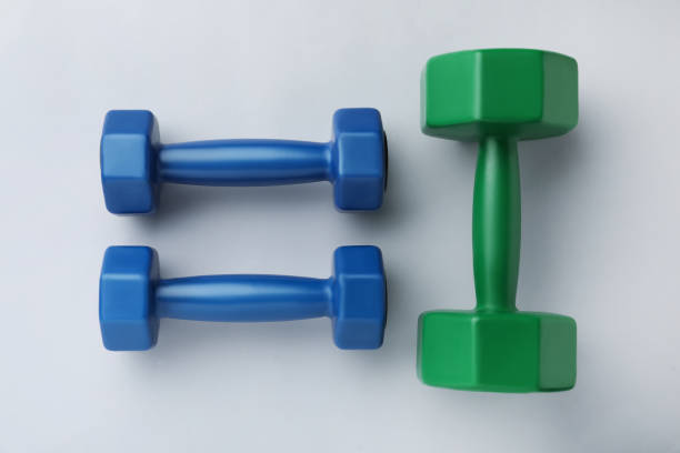 istock Colorful vinyl dumbbells on light background, flat lay 1479535363
