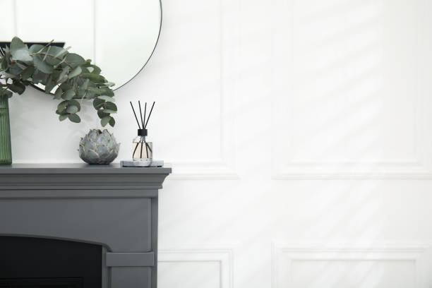 istock Reed diffuser and home decor on grey mantelpiece near white wall. Space for text 1479536792