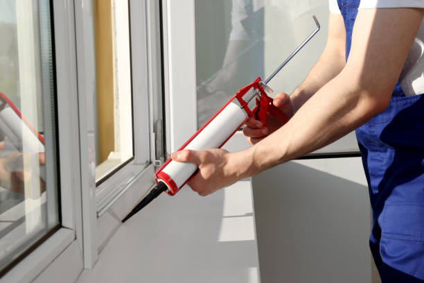 istock Worker sealing plastic window with caulk indoors, closeup. Installation process 1479537901