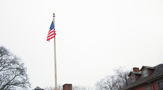 The US flag on a pole is a symbol of patriotism and unity, representing the country's values, history, and people. Its design and colors have symbolic meaning