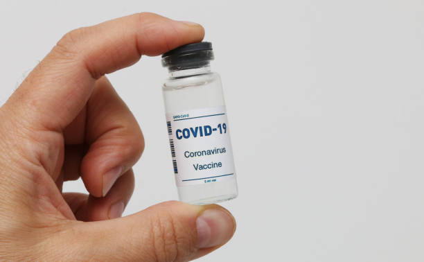 istock Covid-19 vaccine ampoule in hand close-up. 1479544524
