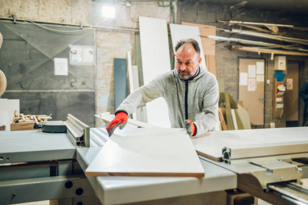 istock A carpenter is working with cutting machine in his woodshop. 1479545148