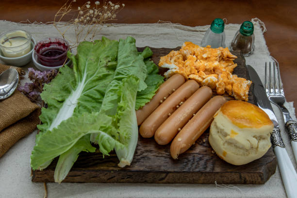 istock Continental breakfast with scrambled eggs, fried sausages, vegetable and scones. 1479546271