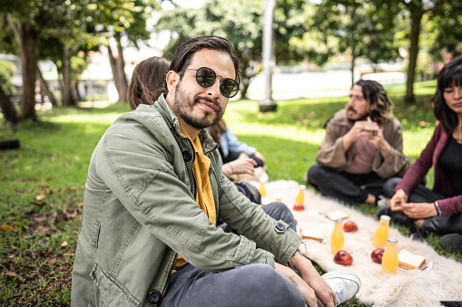 Portrait of a mid adult man on a picnic at public park