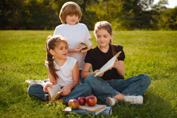 istock children read books, study and prepare for exam or test in park. Bundle of students or pupils learn with textbooks. Education and training concept 1479550043