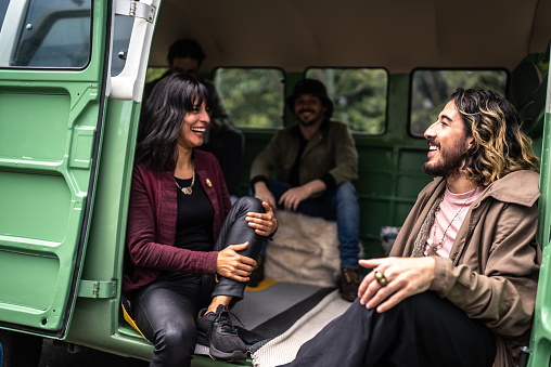 Friends talking on a road trip in a retro mini van