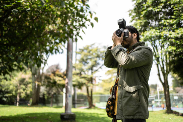 istock Photographer taking a picture at public park 1479553050