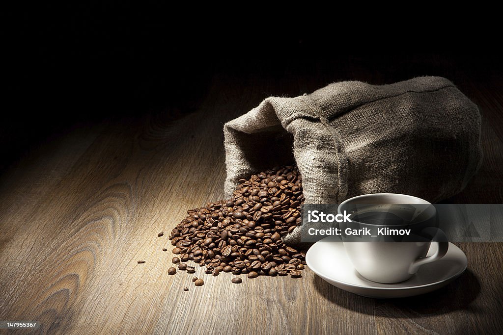 Coffee cup with burlap sack of roasted beans on rustic  Arabic Style Stock Photo