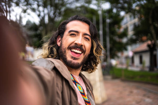 istock Young man taking a selfie outdoors - camera point of view 1479554288