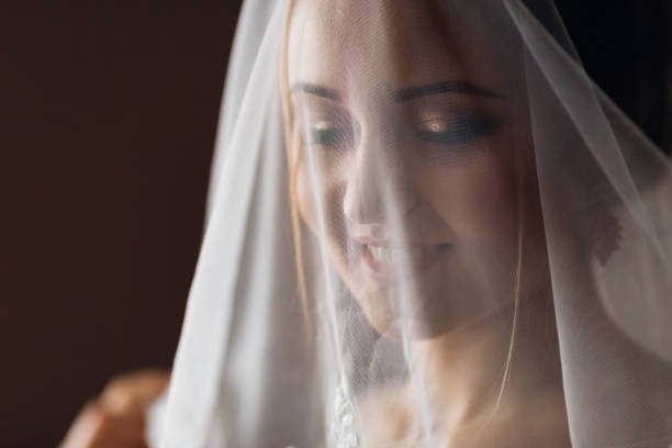 istock bride with gentle makeup covered her face with a wedding veil. c 1479554556