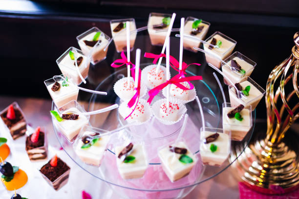 istock cake pops and cupcakes on a transparent stand. candy bar at wedd 1479554596