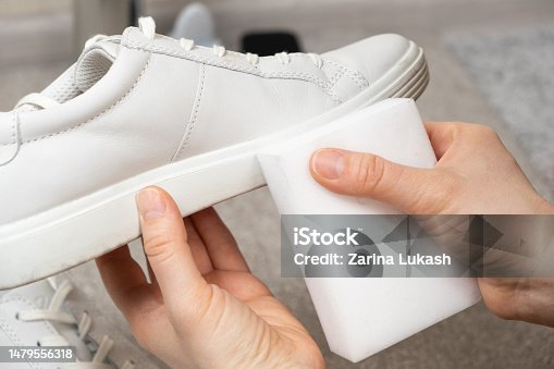 istock Cleaning white shoes and soles from dust and dirt with a melamine sponge 1479556318