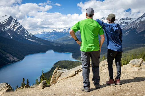 Young Adventurer Couple  Resting and Looking at The View at Peyto Lake, Banff, Alberta, Canada