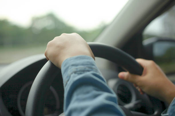 Close up of Hands Driving Car Concept stock photo