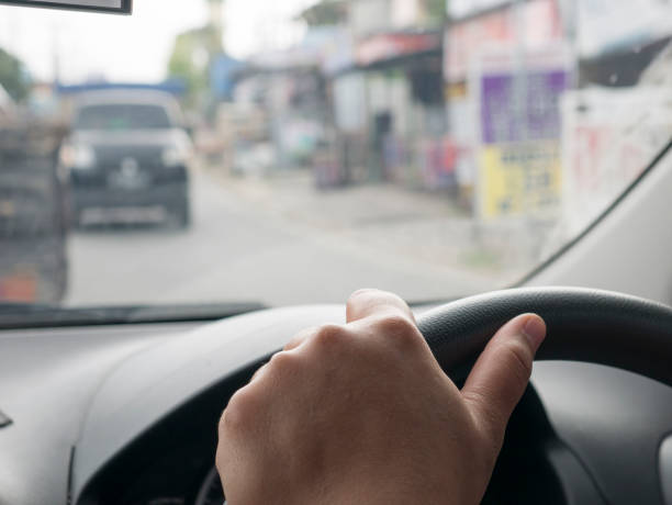 istock Close up of Hands Driving Car Concept 1479569911