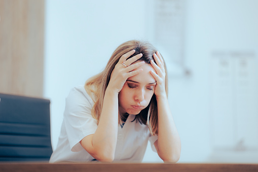 Stressed medical worker feeling the pressure of a difficult job