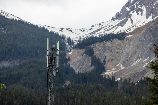Telecommunication tower in a mountain remote area. Telecom tower antennas and satellite transmits the signals of cellular 5g 4g mobile signals to the consumers and smartphones.