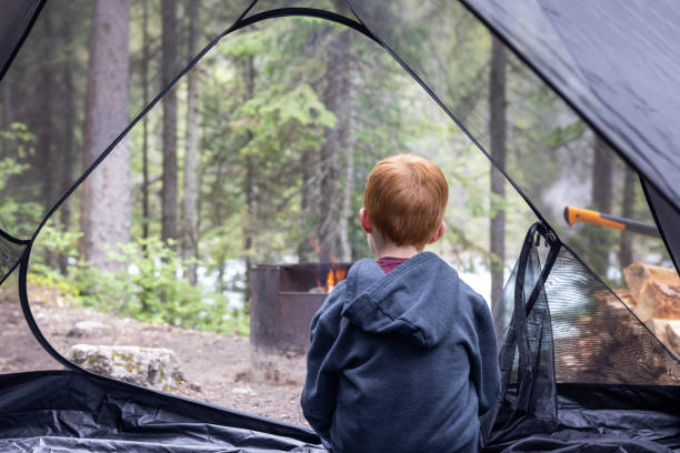 istock Young Redhead Boy Inside a Tent at Camping Site Close to Campfire, Yoho National Park, Bc, Canada 1479574181
