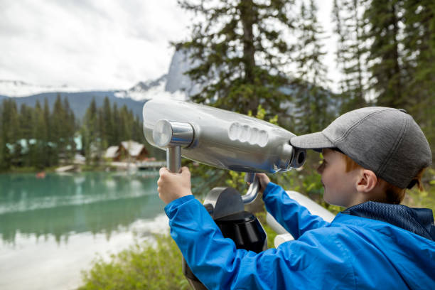 istock Young Boy Looking in Binoculars at Emerald Lake, British Columbia, Canada 1479574313