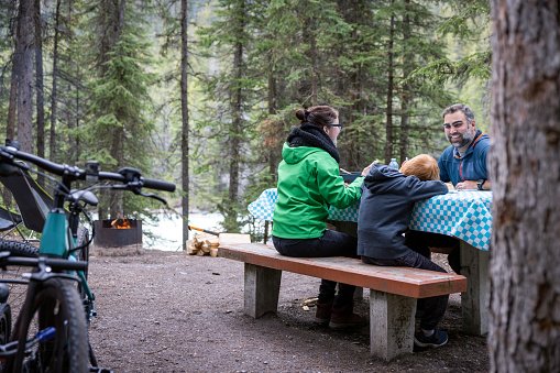 Family Eating Outdoor at Camping Site Close to Campfire, Yoho National Park, Bc, Canada
