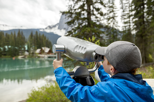 Young Boy Looking in Binoculars at Emerald Lake, British Columbia, Canada