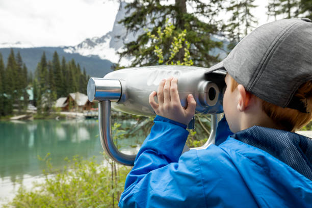 istock Young Boy Looking in Binoculars at Emerald Lake, British Columbia, Canada 1479574569