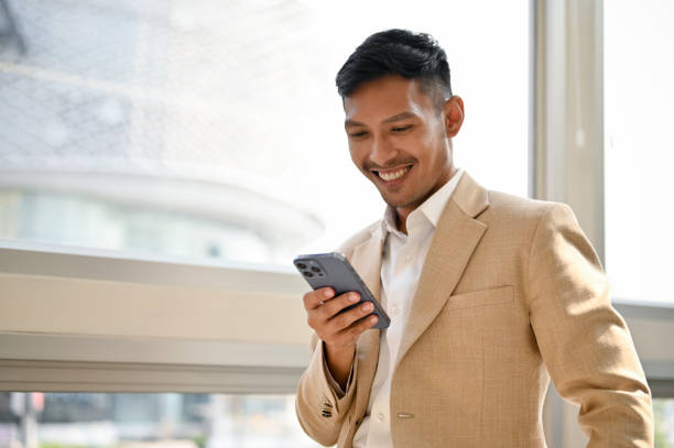 istock Successful Asian businessman using his smartphone in his modern office. text, chat 1479585961