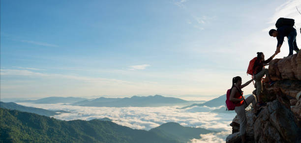 istock Asian hiking help each other on mountains 1479586155