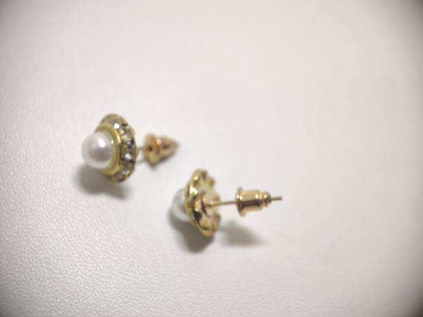 Closeup many type of earrings on white tray