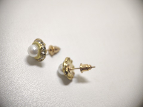 luxury pair freshwater pearl earrings, made of gold, and quite expensive because they are made specifically by hand, white background