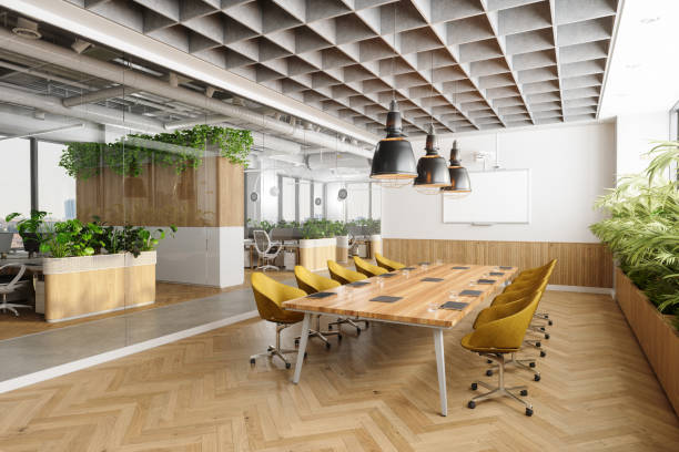 Eco-Friendly Open Plan Modern Office Interior With Meeting Room. Wooden Meeting Table, Yellow Chairs, Plants And Parquet Floor stock photo