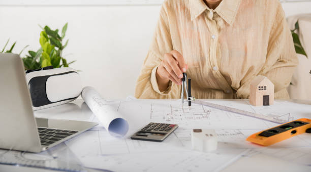 istock Architect drawing with divider compass on house plan blueprint paper 1479589037