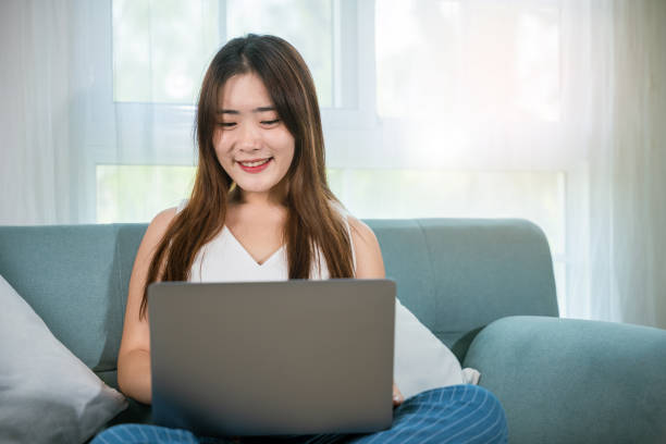 istock Happy woman browsing through the internet during free time on laptop computer 1479589075