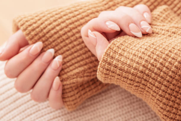 istock womans hands with manicure with  knitted blanket 1479594025