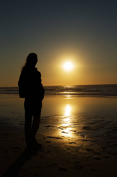 istock Woman sunset silhouette 147959423