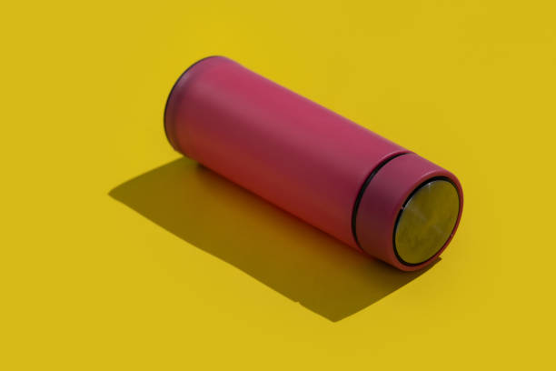 istock Pink empty traveler bottle & drink container template on yellow background 1479595496