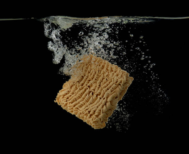 istock Instant noodles into water over dark background,cooking instant noodle 1479595792