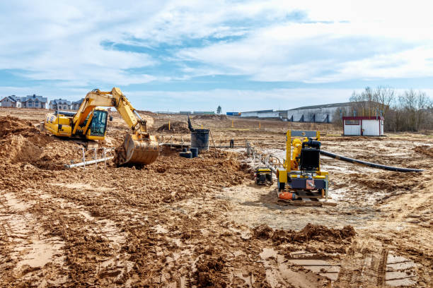istock Excavator dig the trenches at a construction site. Trench for laying external sewer pipes. Sewage drainage system for a multi-story building. Digging the pit foundation 1479597401