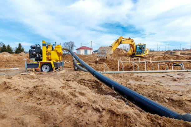 istock Excavator dig the trenches at a construction site. Trench for laying external sewer pipes. Sewage drainage system for a multi-story building. Digging the pit foundation 1479597419