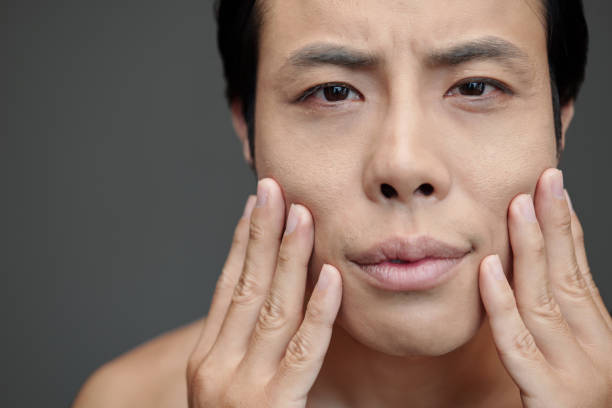 istock Man Applying Anti-aging Treatment 1479597470
