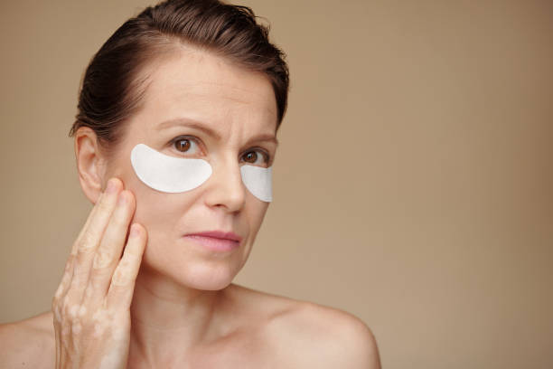 istock Woman Applying Undereye Patches 1479597509