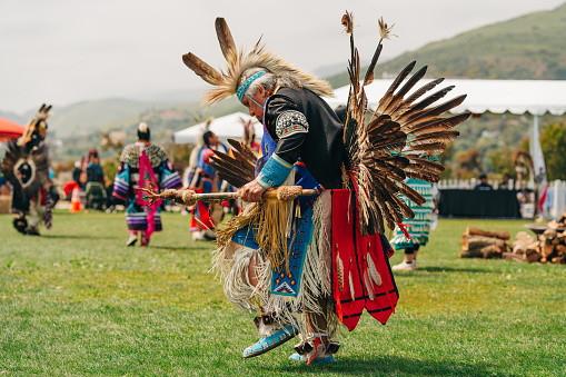 Malibu, California, USA - April 2, 2023. Male Pow Wow dancers in colorful outfits, Chumash Day Pow Wow, and Inter-tribal Gathering. The Malibu Bluffs Park is celebrating 23 years of hosting the Annual Chumash Day Powwow.