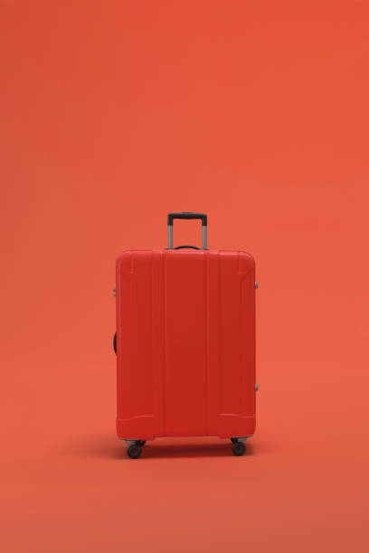 istock Red Suitcase on pink or magenta background. travel vacations concept. 1479606829