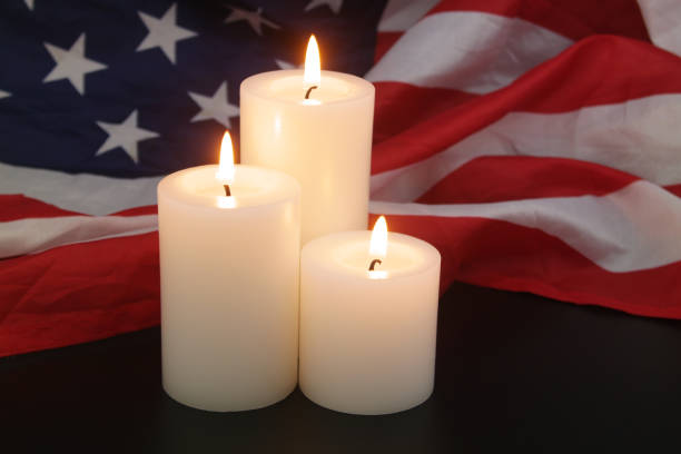 istock Burning candles on USA flag background. 1479608766