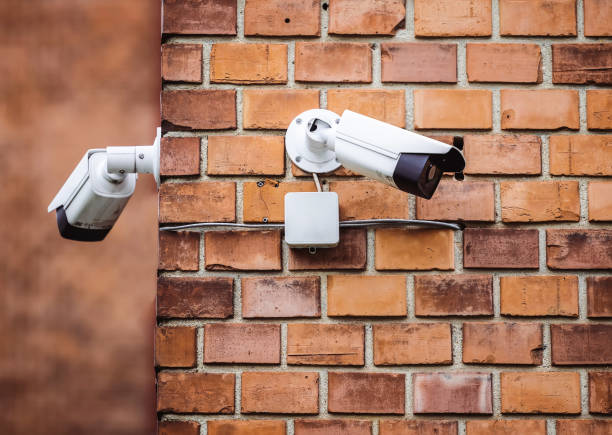 istock Group of security cameras on red brick wall 1479612642