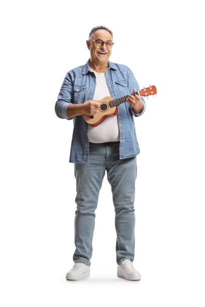 Full length portrait of a mature man playing ukulele Full length portrait of a mature man playing ukulele isolated on white background ukulele stock pictures, royalty-free photos & images