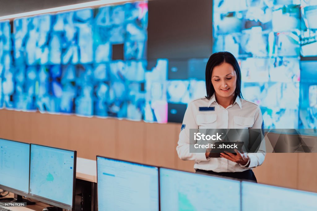 Female Security Operator Working In A Data System Control Room Offices ...