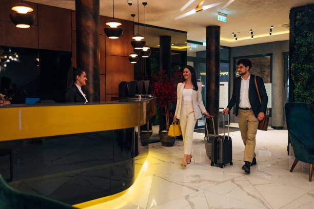 istock A smiling receptionist in uniform welcomes hotel guests 1479624598
